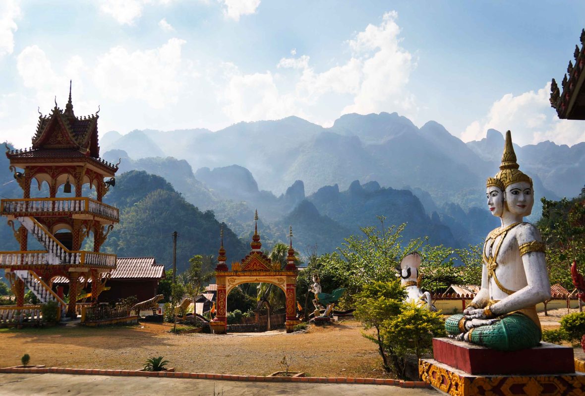 Mountains in the background and a temple in the foreground.