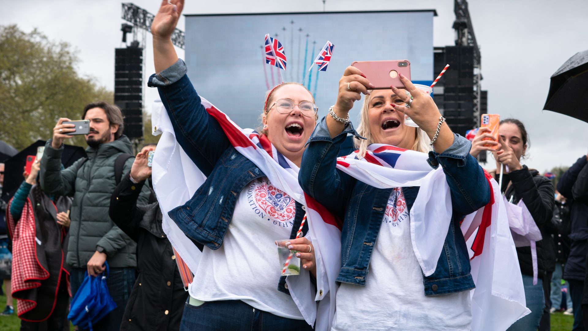 Two women pose for a selfie in the crowds.