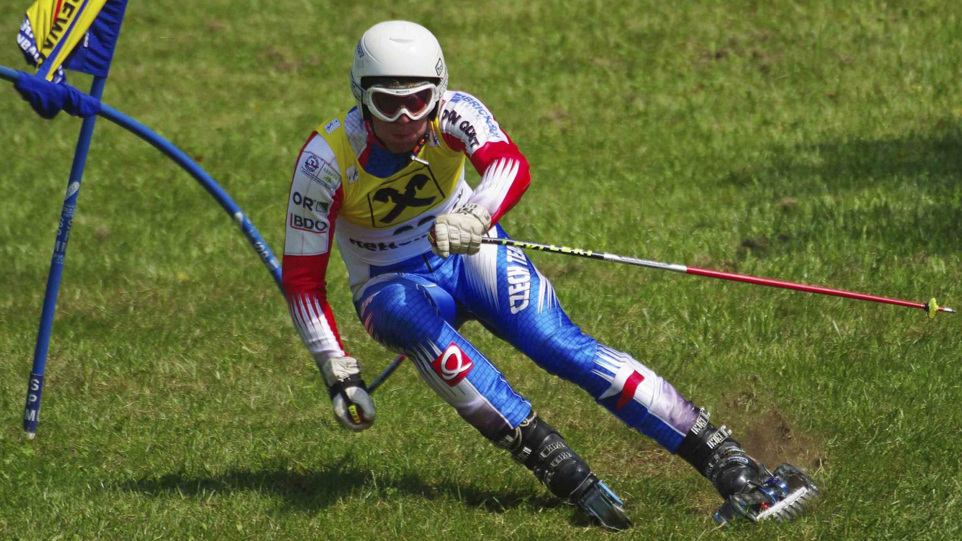 A woman competes in a grass skiing competition.